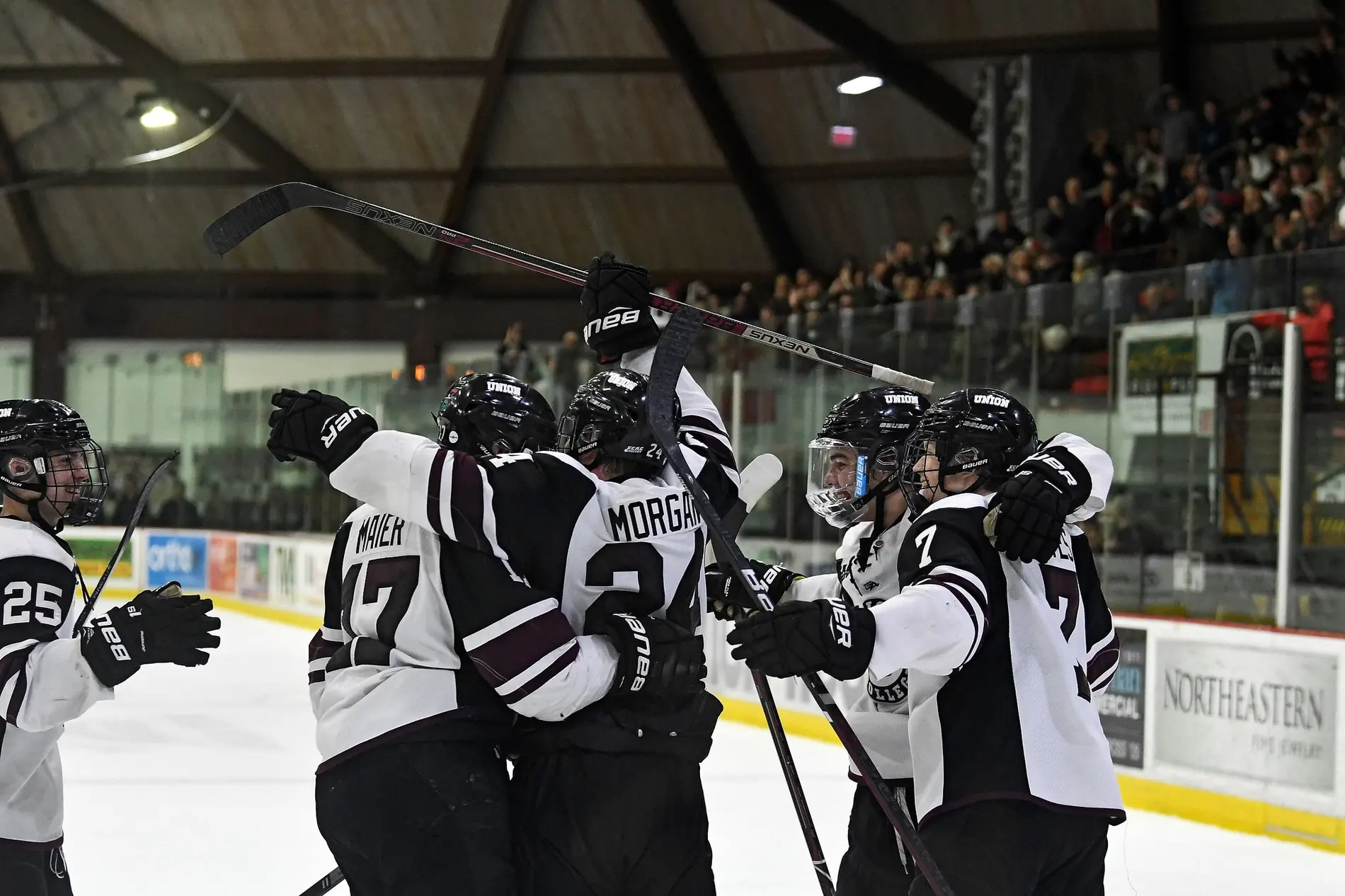 Union College men's ice hockey players celebrating a goal on the ice